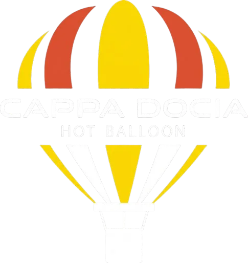 Hot air balloon floating above golden desert dunes at sunrise in Dubai